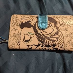 Iron fist wallet with sugar skull in writing with roses, white, black and blue